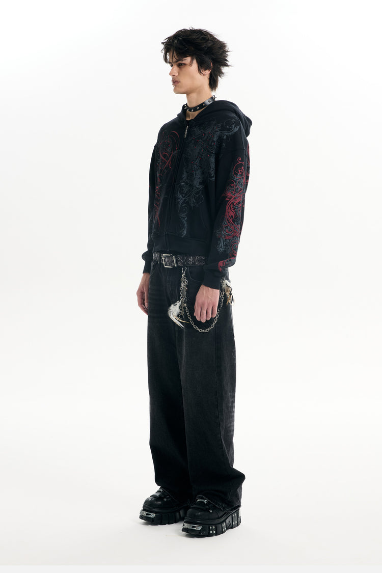 Full-length side view of the Black Scripture Eclipse Zip Up Hoodie with baggy black jeans