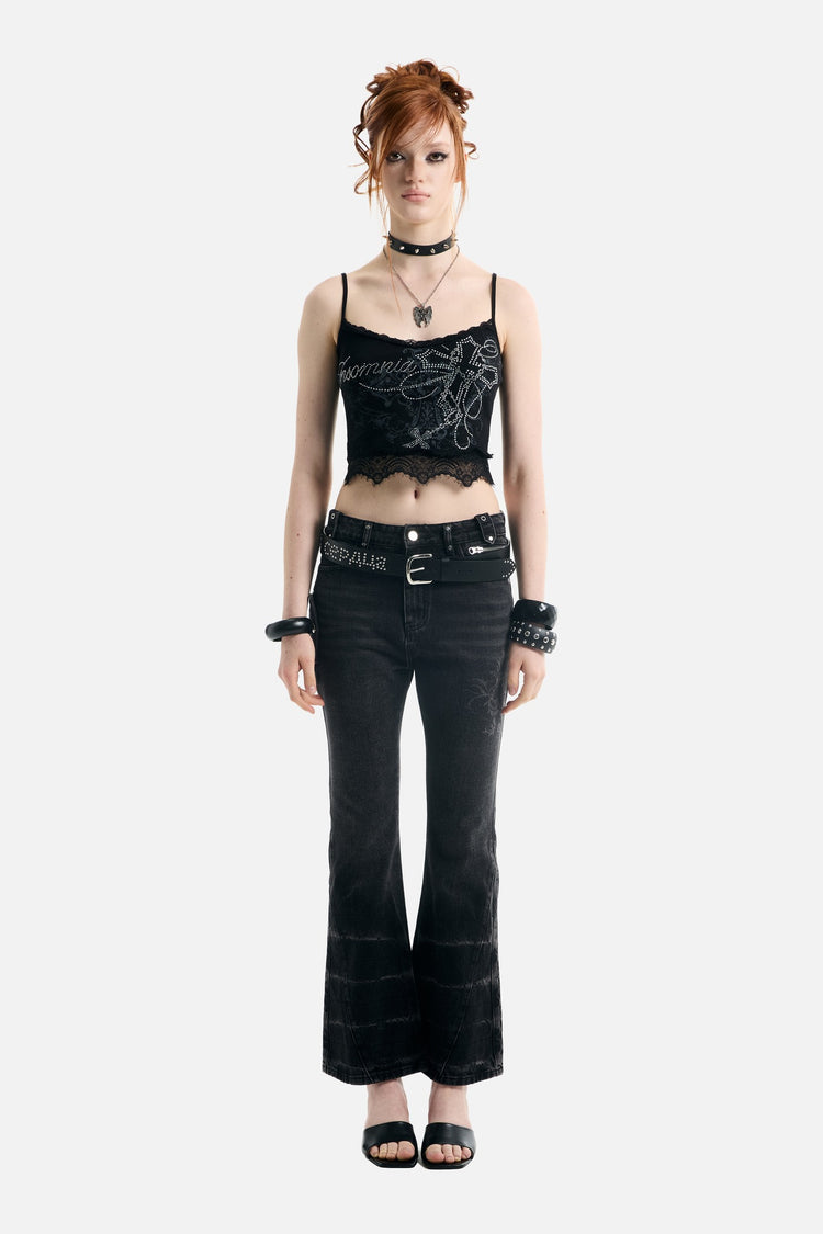 Full-length front view of the Blessed Rhinestone Lace Crop Tank styled with black flared jeans
