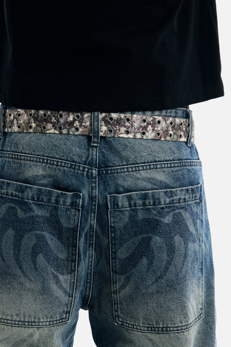 Back view of the Camo Skull Belt worn with a black tee and tribal print jeans