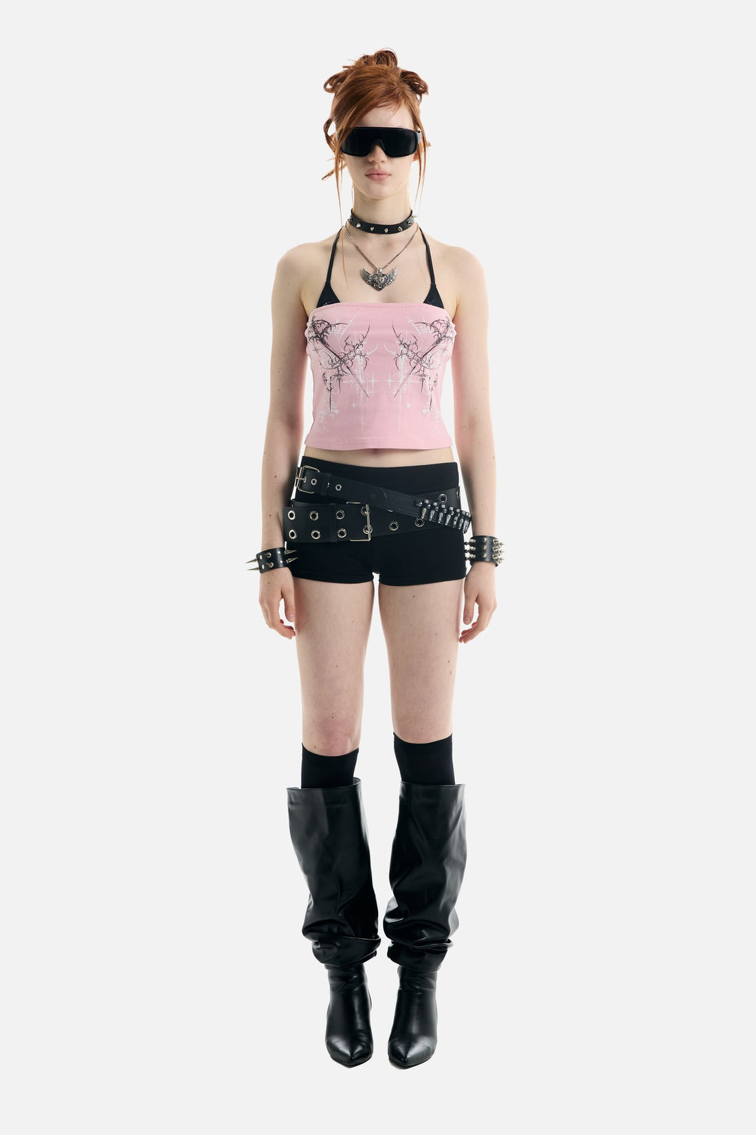 Full-length front view of the pink Dagger Tube Top with black shorts and slouch boots