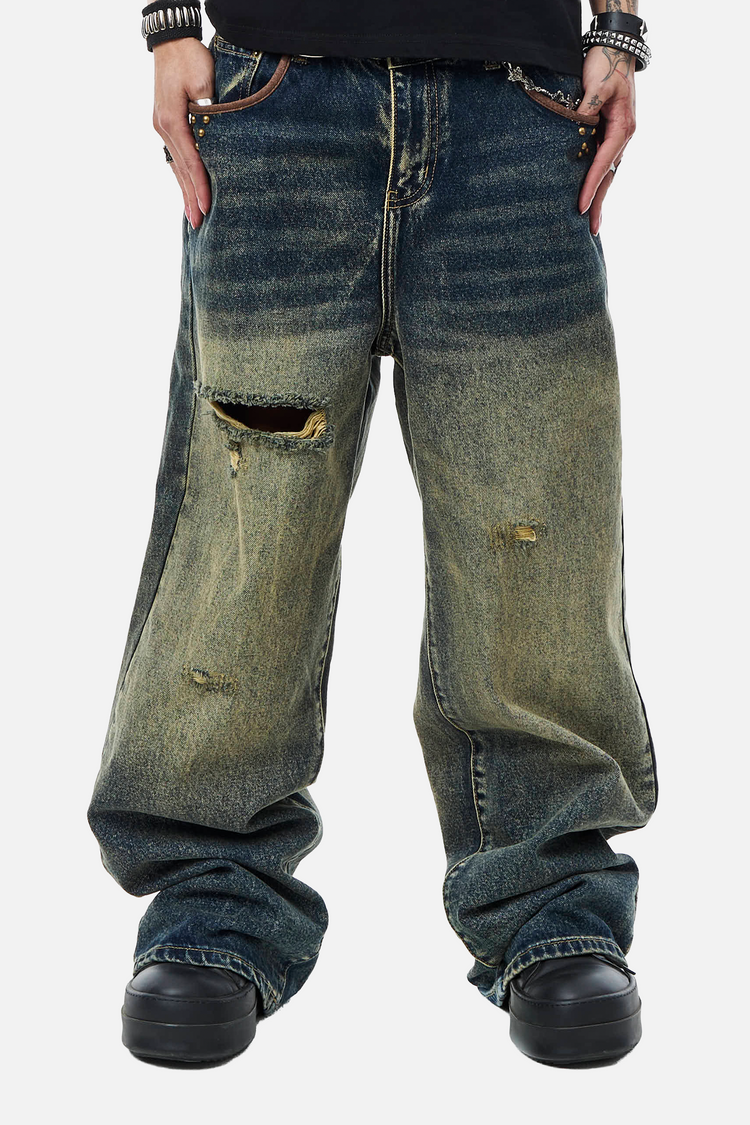 Front view of the faded blue Embellished Outlaw Denim with ripped knee, worn baggy