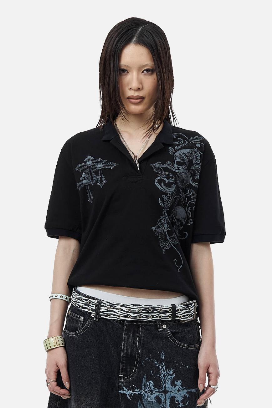 Model wearing the Skull Garden Polo cropped, with a zebra belt and printed black jeans