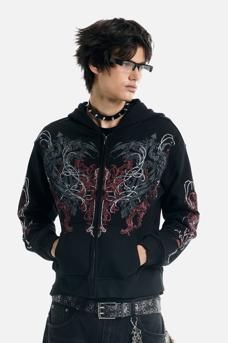 Model wearing the zipped Harmony Hoodie with glasses and spiked choker, hands in pockets