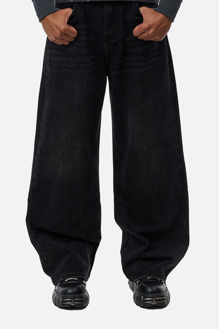 Front view of the washed black Harmony Jeans, wide-leg fit with black chunky shoes