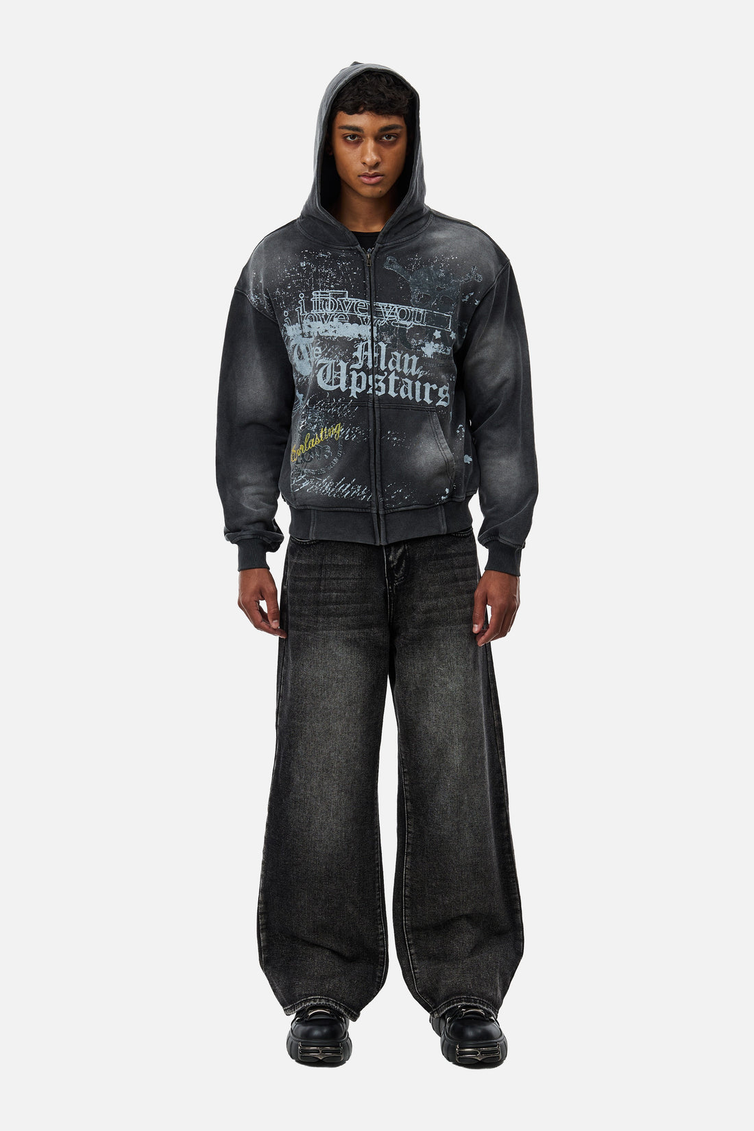 Full-length front view of the Washed Black Outlaw Denim styled with a graphic zip hoodie