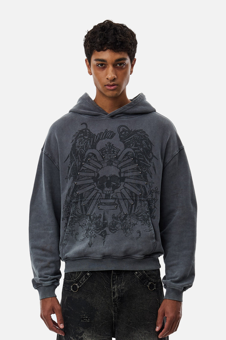 Model wearing the grey washed Crest Hoodie with skull crest print, front view