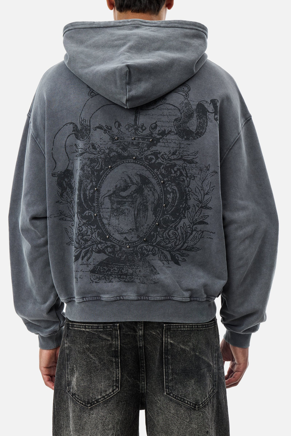 Back view of a model in the Crest Hoodie showing the large crest print