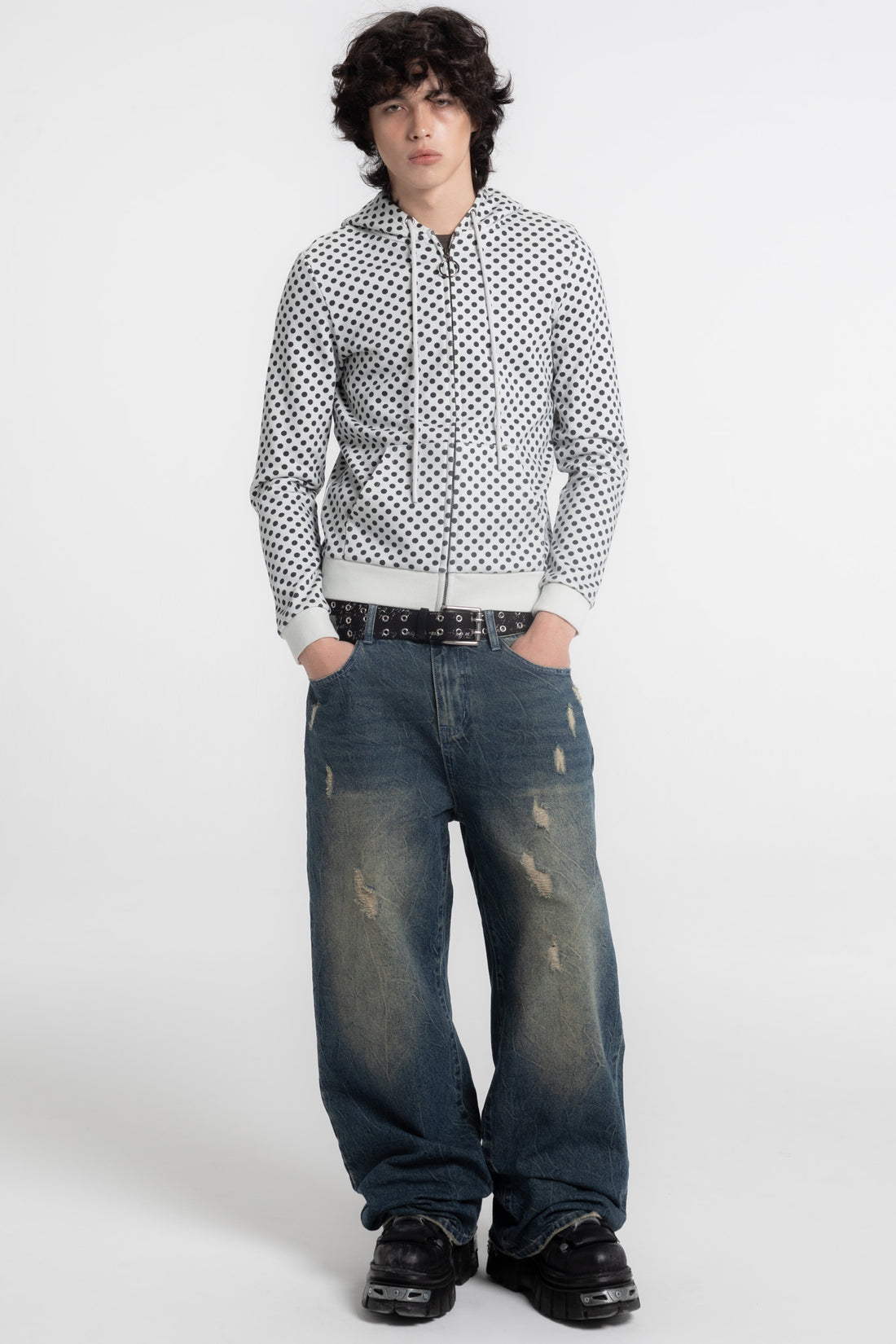 Model wearing the Polka Dot Slim Zip Hoodie with baggy faded jeans, full-length front view