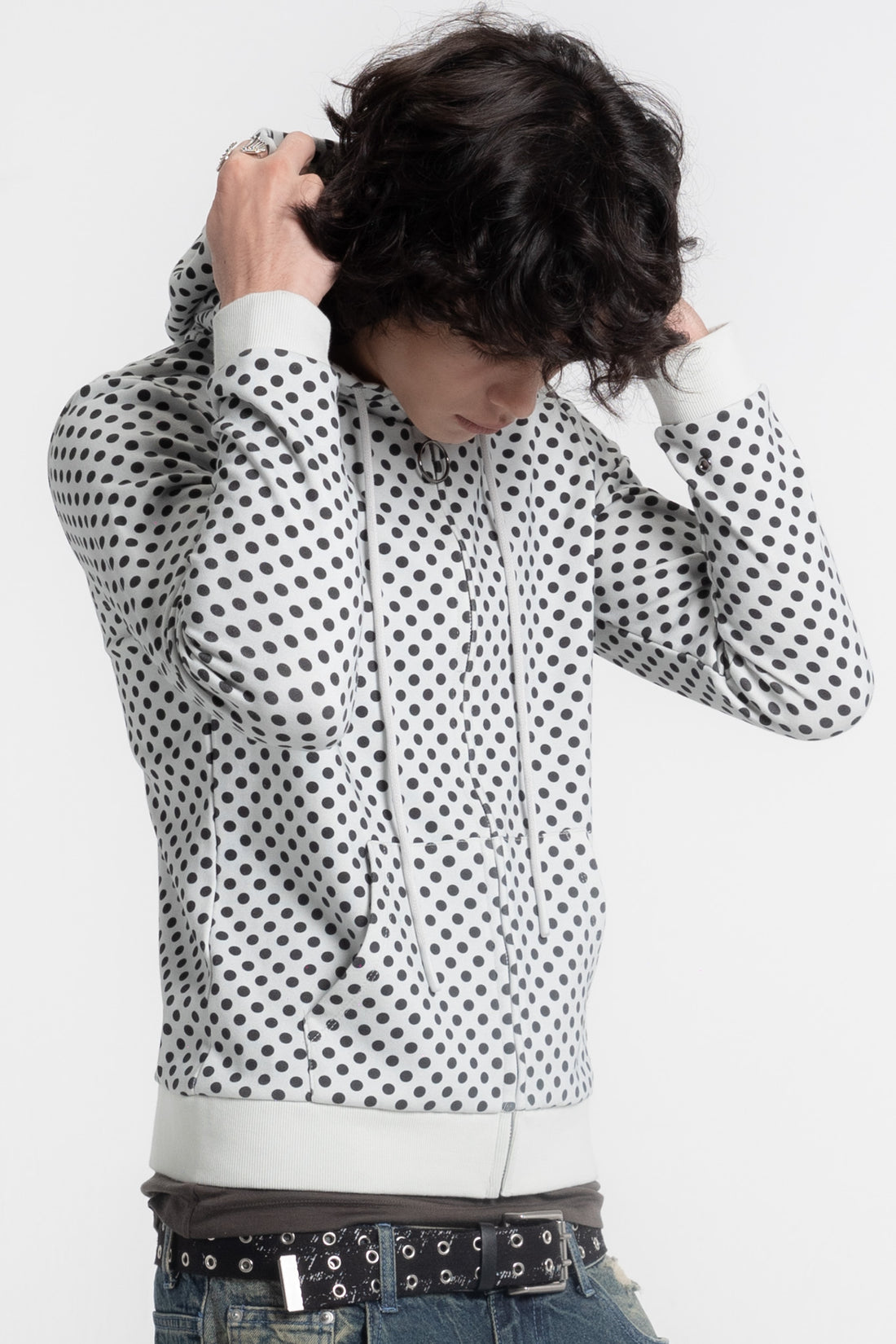 Model pulling up the hood of the Polka Dot Slim Zip Hoodie, close front view