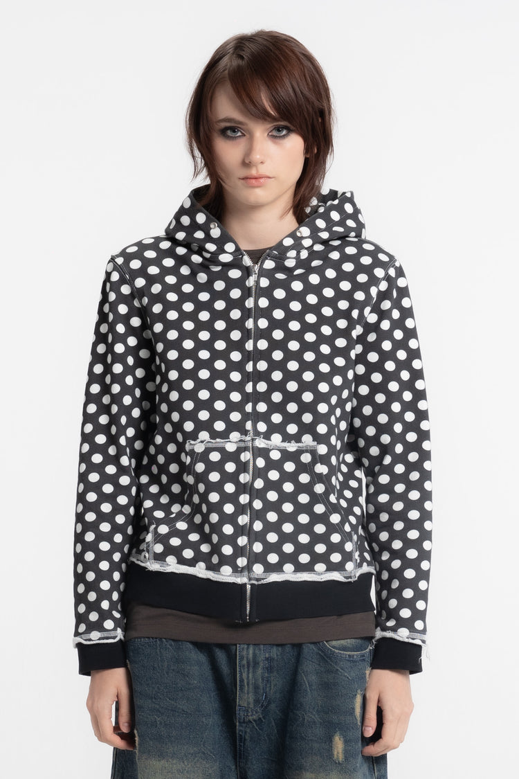 Model wearing the Black Polka Dot Slim Zip Hoodie zipped up, front close-up view