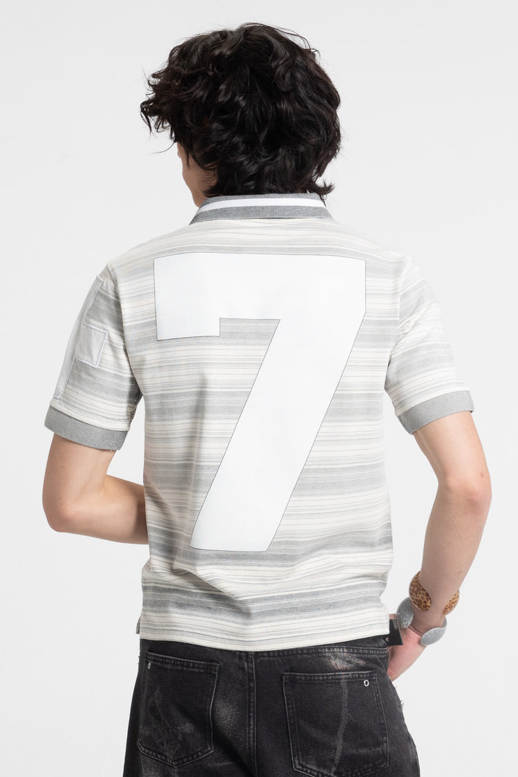 Back view of the Striped Crest Polo on model, showing the large white number 7