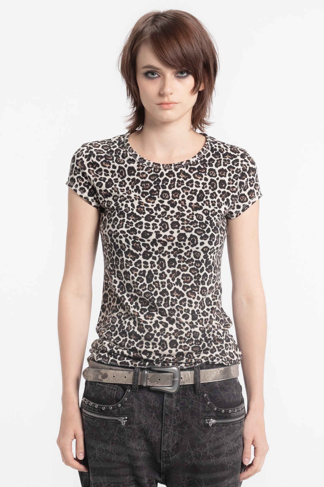 Model in the Cheetah Slim Tee with studded belt and dark jeans, front view