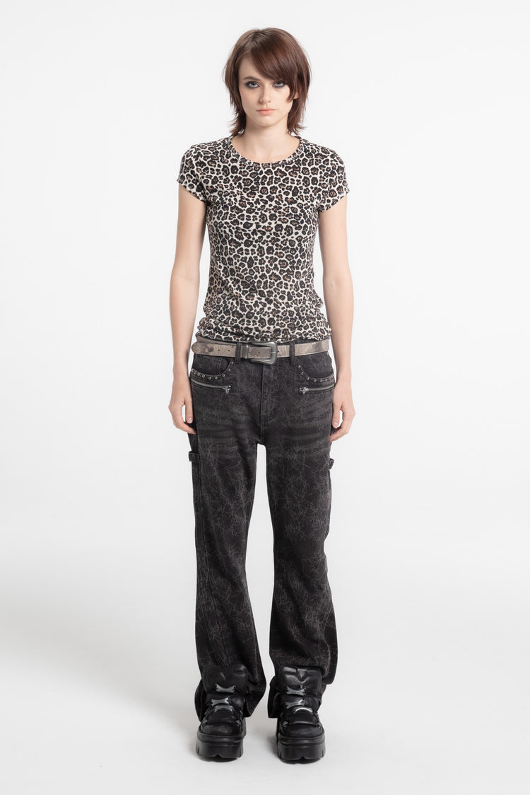 Model wearing the Cheetah Slim Tee with dark baggy jeans and platform boots, full-length view