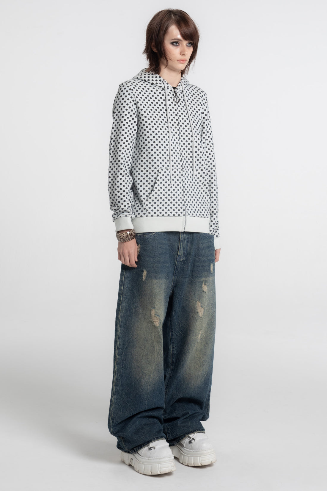 Model in the Polka Dot Slim Zip Hoodie with baggy jeans and white sneakers, full length