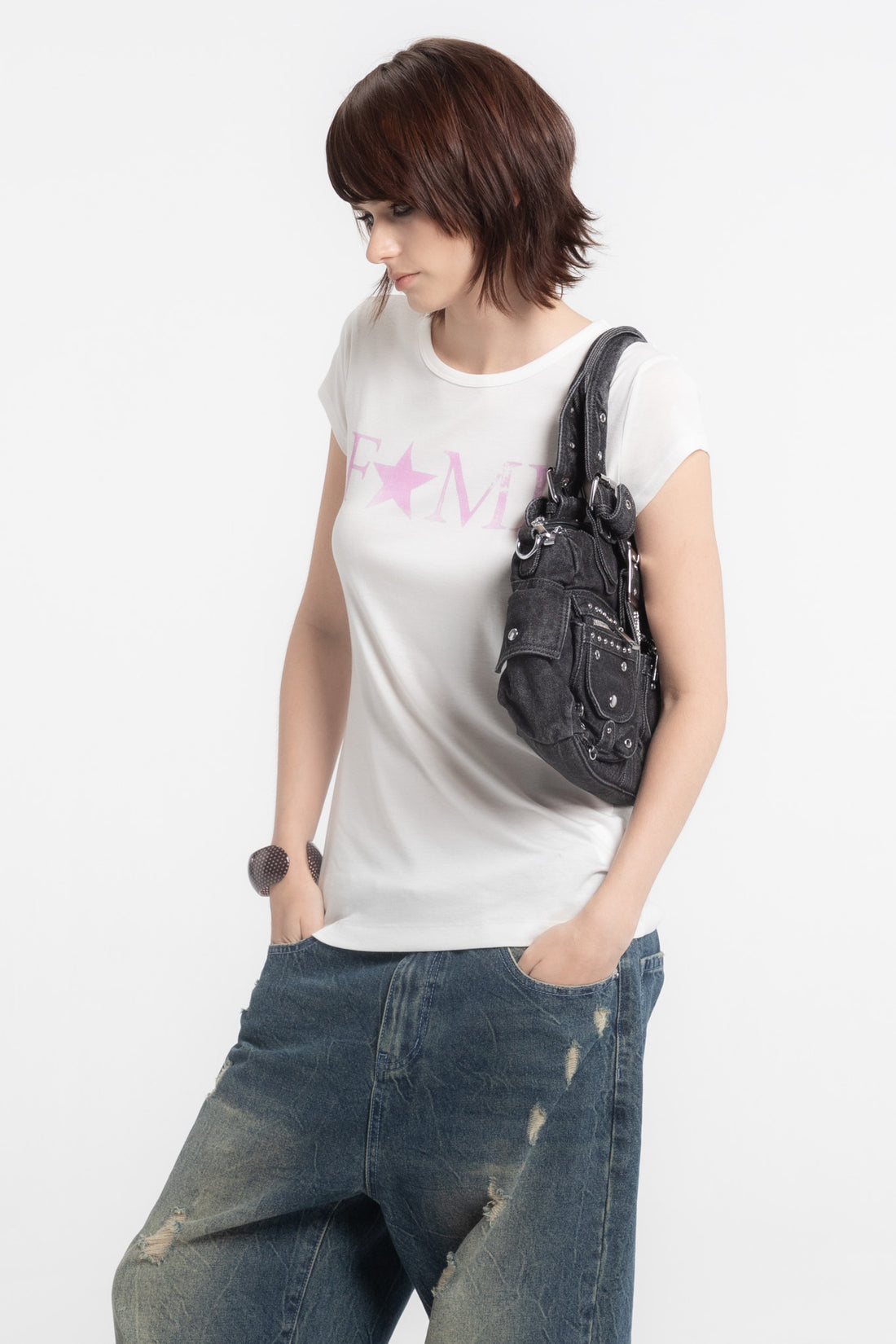 Side view of the black Cross Denim Shoulder Bag worn under the arm