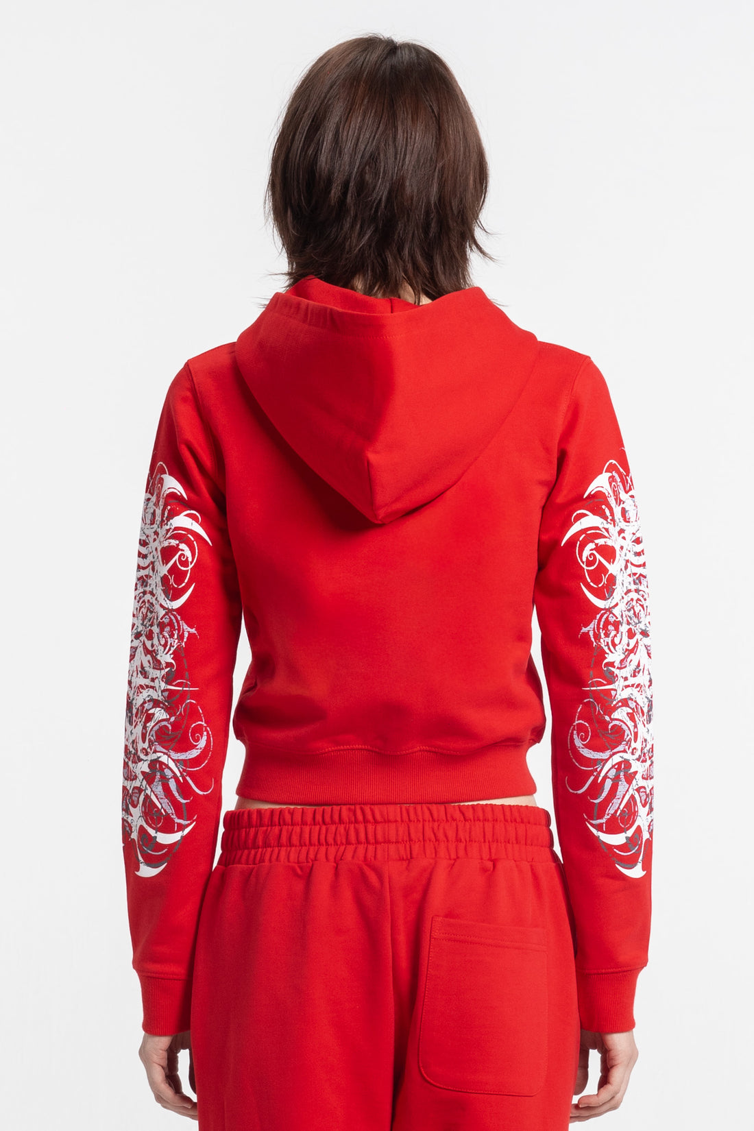 Back view of the Red Eclipse Cropped Hoodie with white printed sleeves