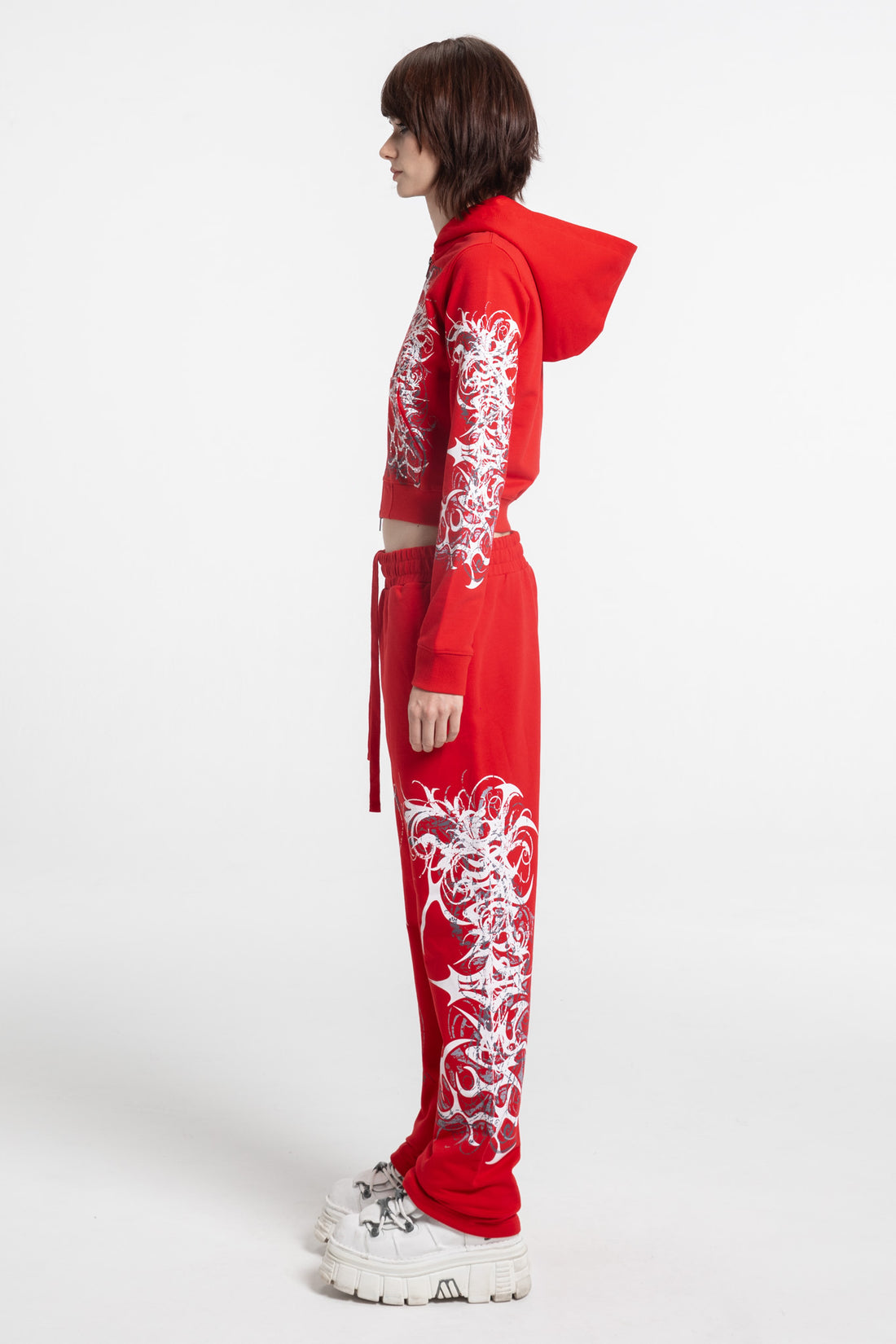 Full-length side view of the Red Eclipse Cropped Hoodie and red sweatpants