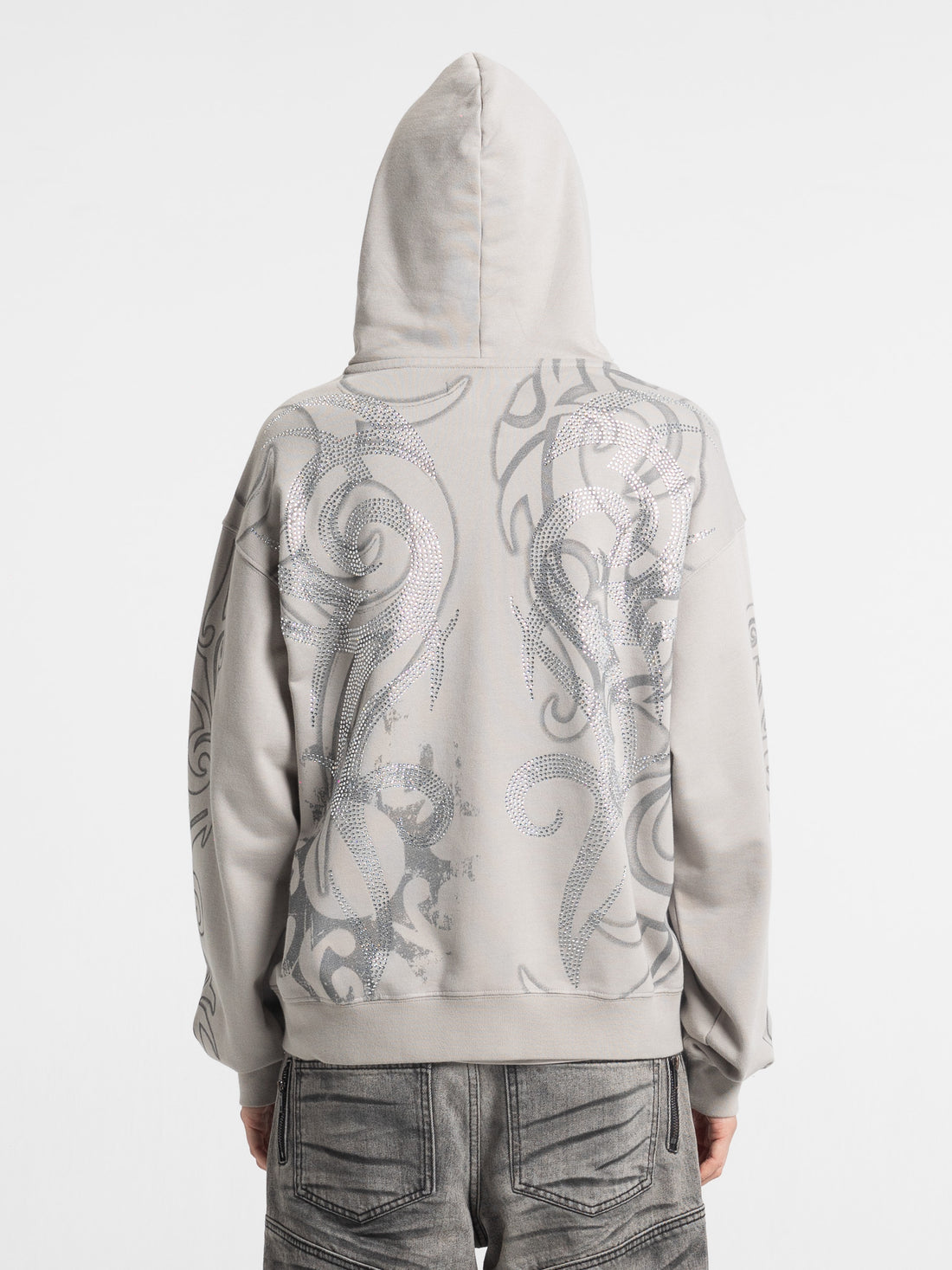Close back view of the Rhinestone Tribal Zip Hoodie with hood up, showing rhinestone tribal design