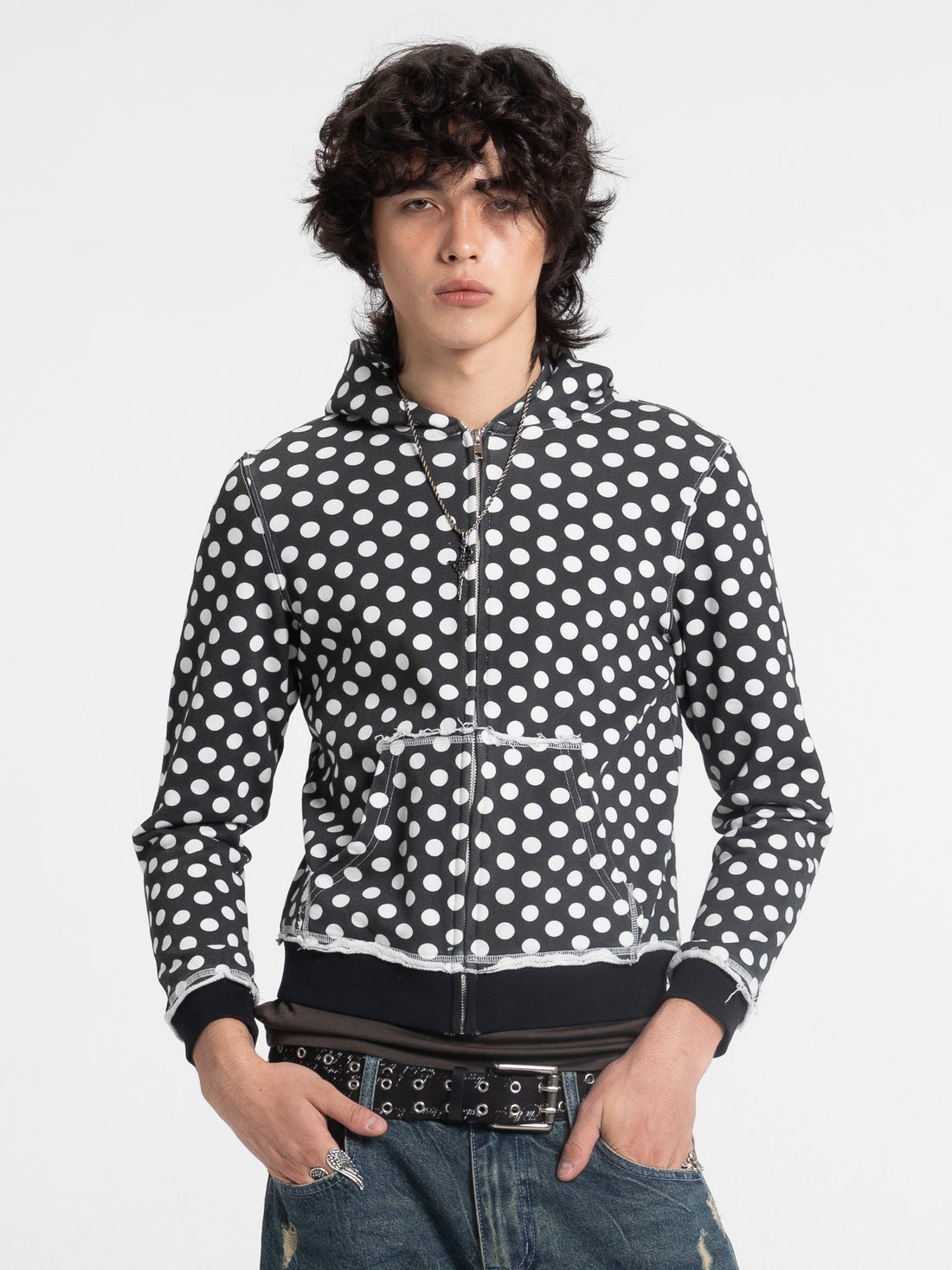 Model in the Black Polka Dot Slim Zip Hoodie with white dots, front view with studded belt