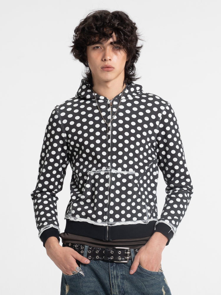 Model in the Black Polka Dot Slim Zip Hoodie with white dots, front view with studded belt