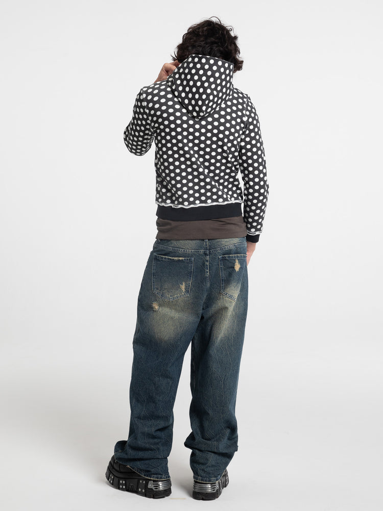 Back view of the Black Polka Dot Slim Zip Hoodie worn with hood up and baggy jeans