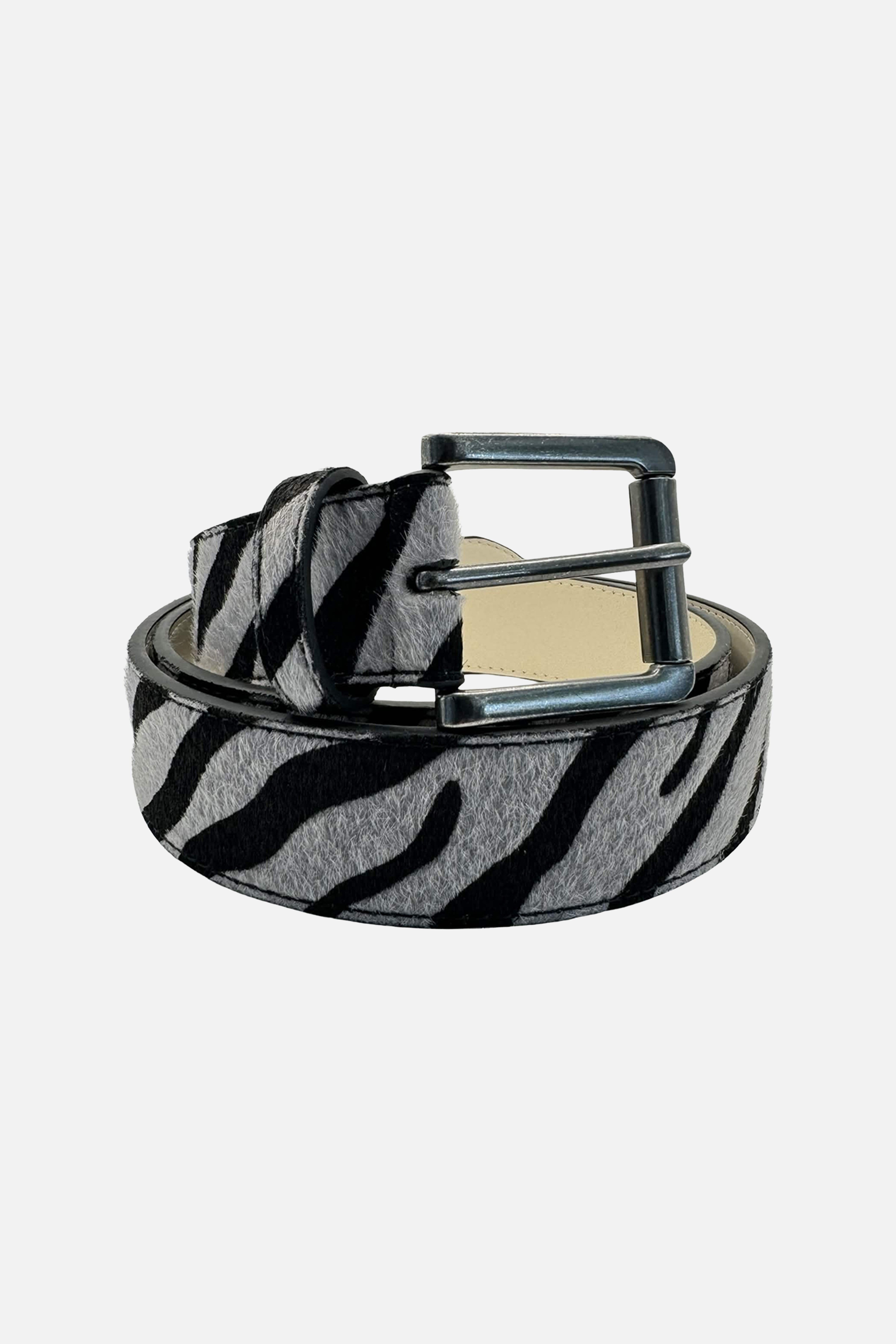 Night Tiger Belt — coiled product shot with gunmetal buckle