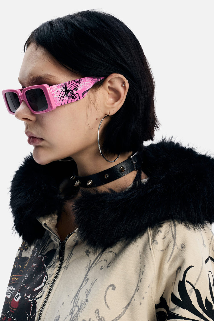 Side profile of a model in the pink Note Glasses showing the printed arm