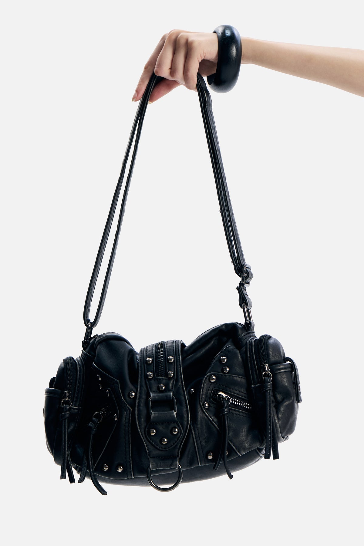PU Leather Side Rodeo Bag held by its strap, showing studs, side pockets and buckle