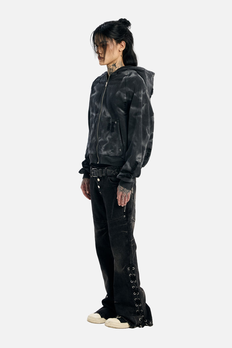 Full-length side view of the Studded Raglan Zip Up Hoodie and black flared jeans