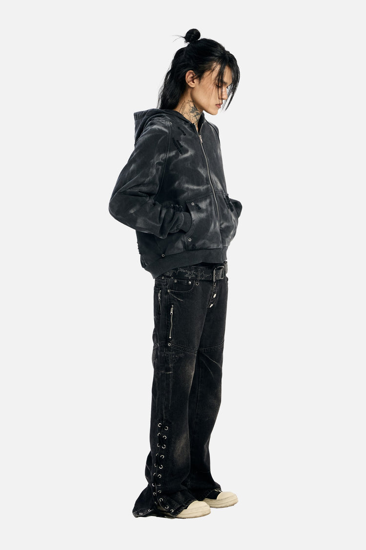 Three-quarter view of a model in the Studded Raglan Zip Up Hoodie looking down