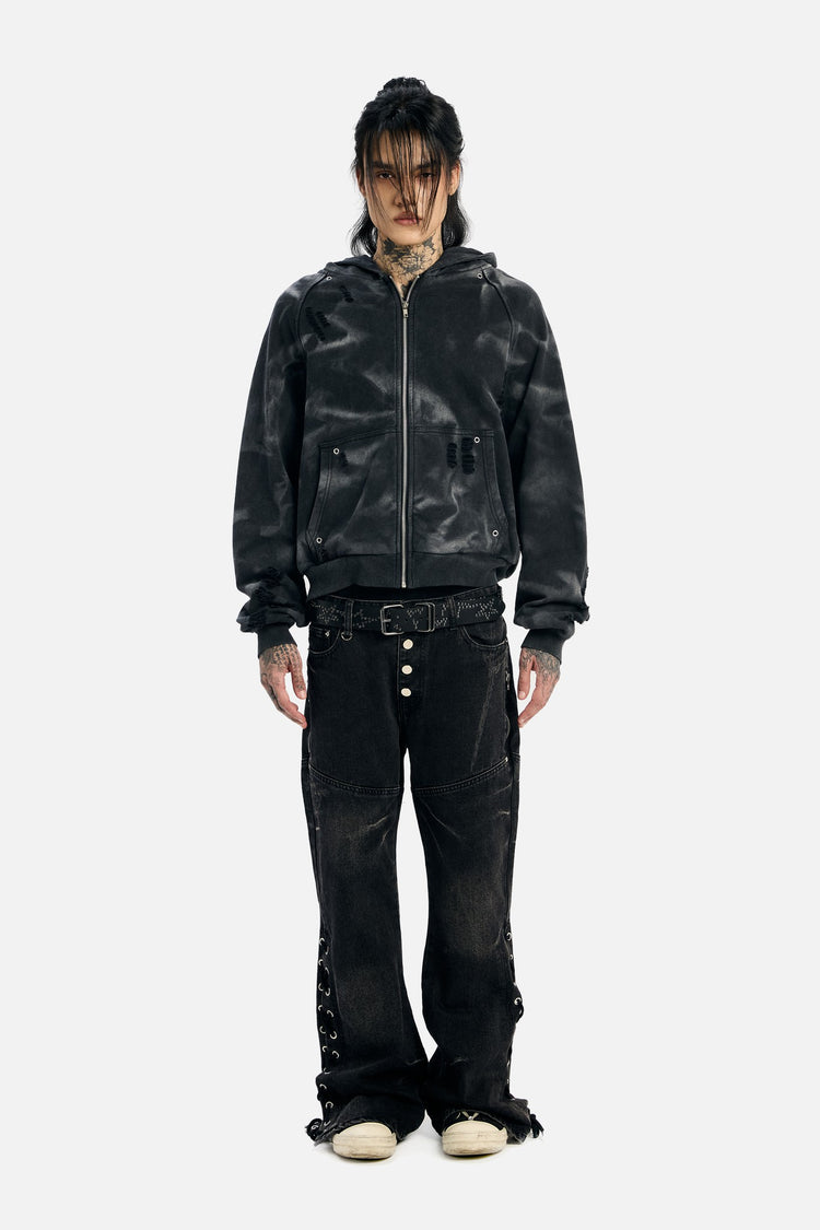 Full-length front view of the Studded Raglan Zip Up Hoodie with flared black jeans