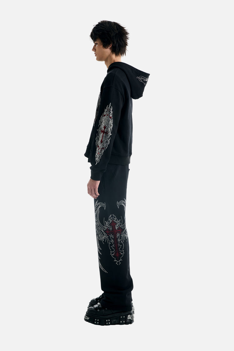 Side view of the Red Cross Baggy Sweats with matching hoodie, showing red cross wing graphic