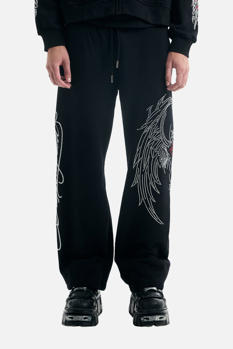 Front view from the waist down of the black Red Cross Baggy Sweats with drawstring waist