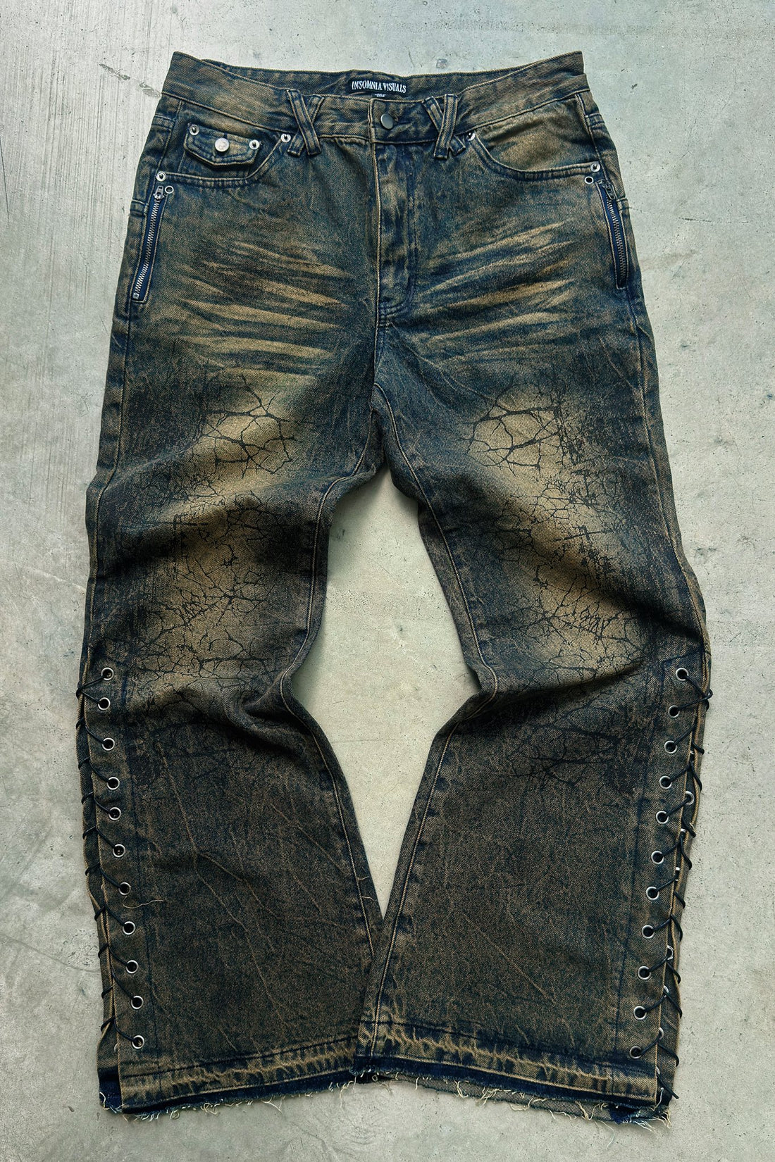 Shattered Rogue Denim laid flat on concrete