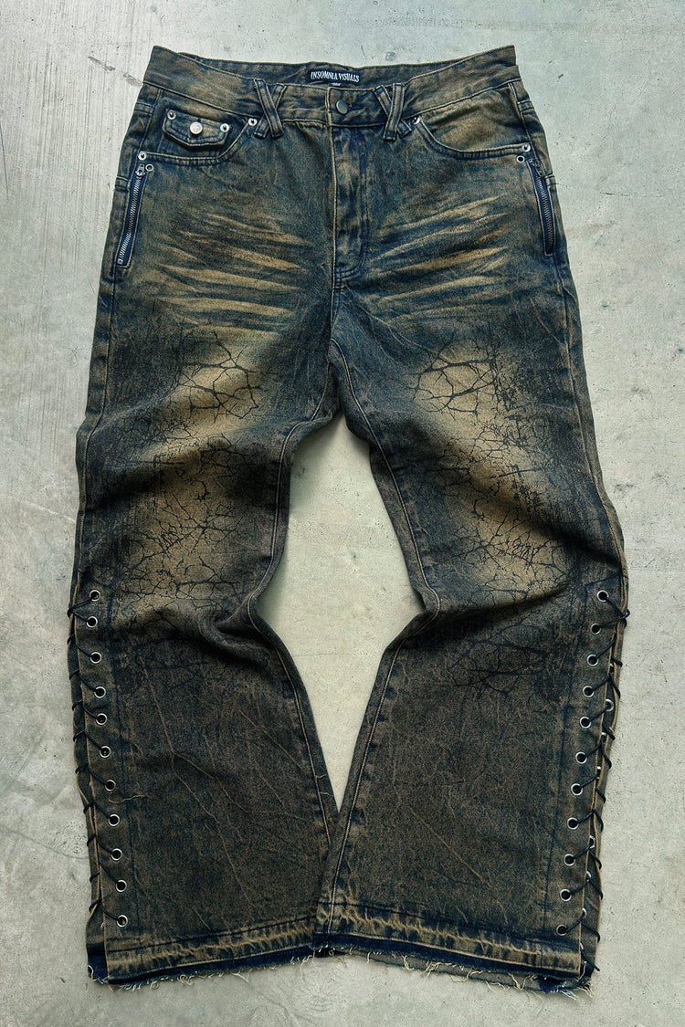 Shattered Rogue Denim laid flat on concrete
