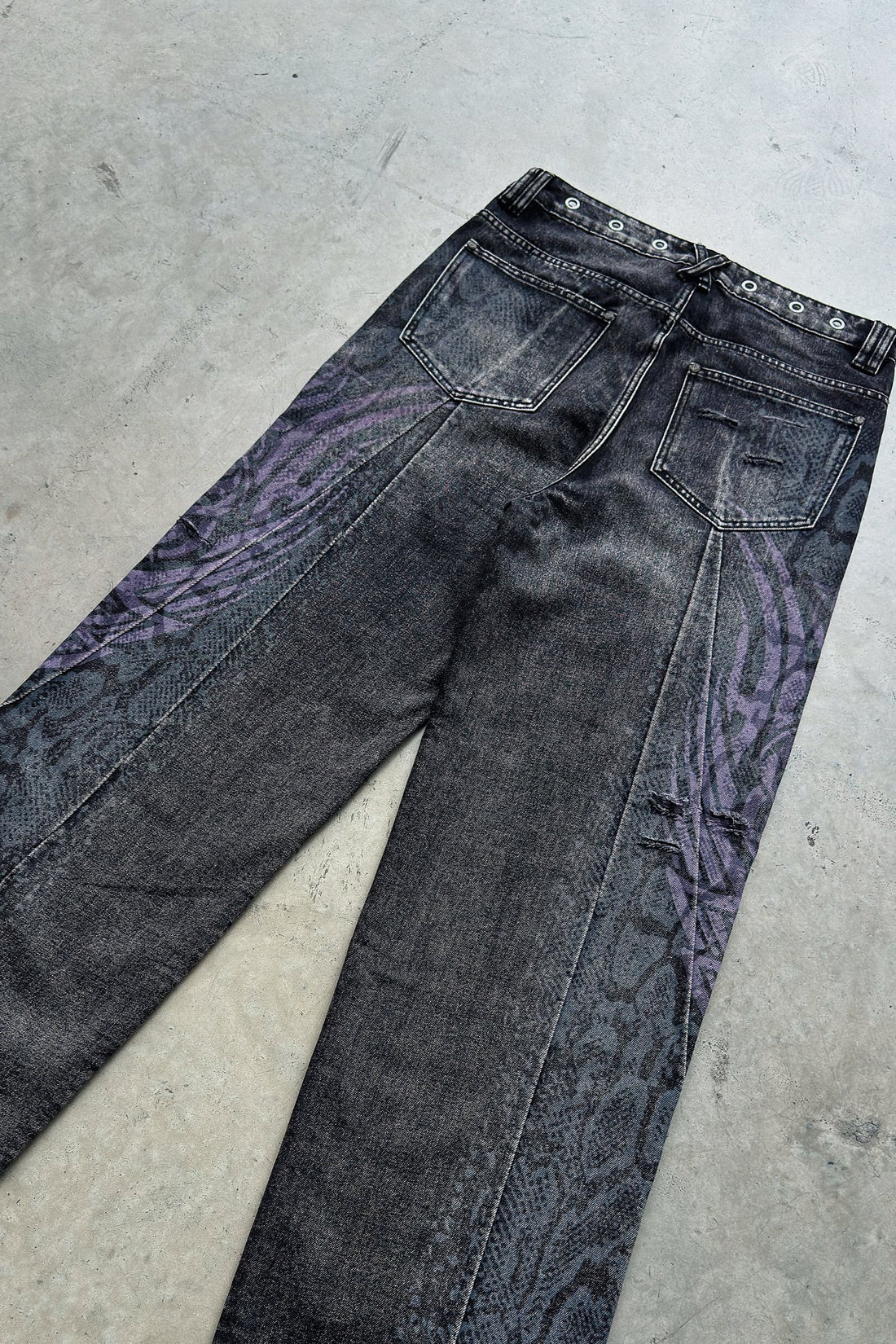 Snakeskin Tribal Destroyer Denim laid flat on concrete