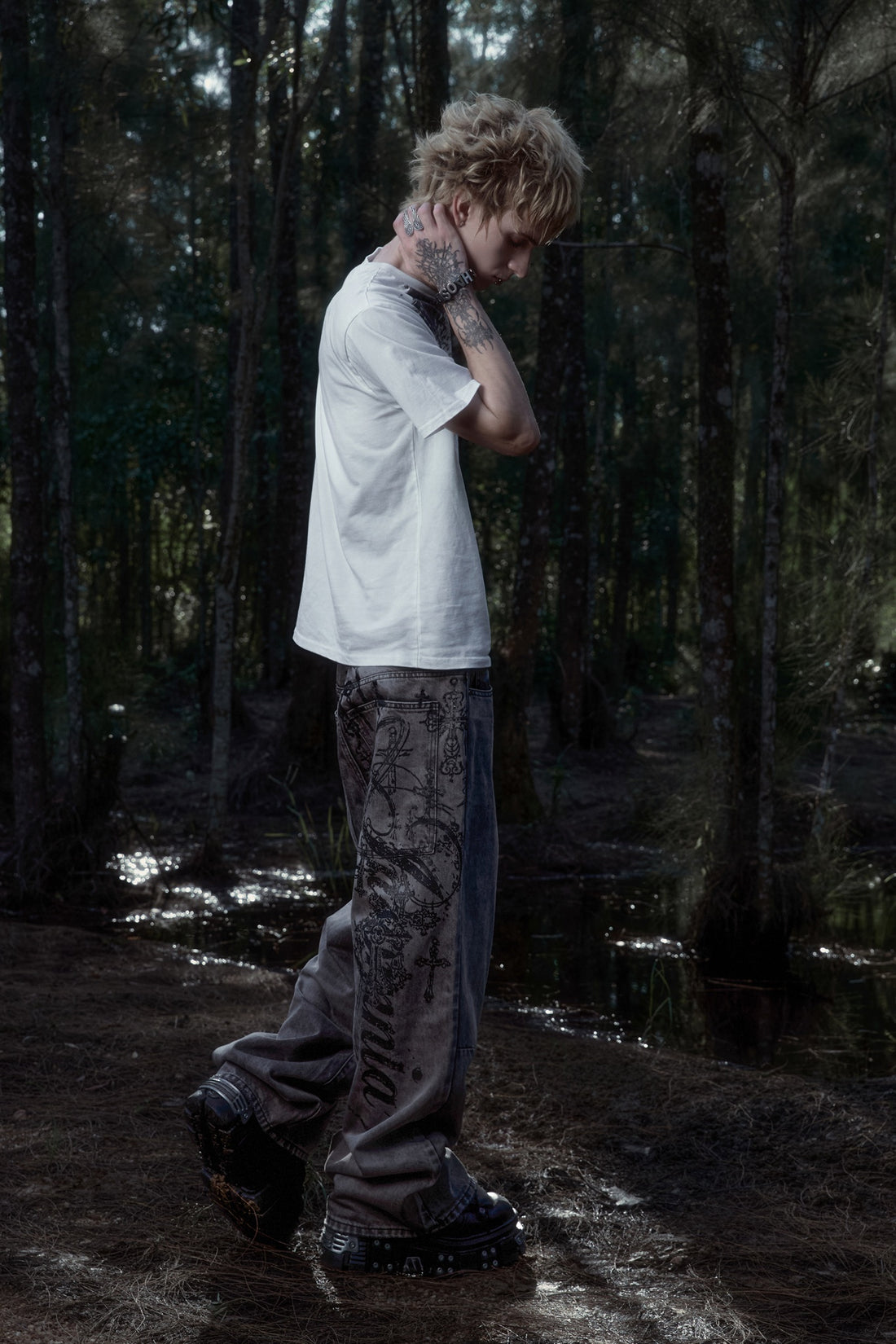Scripture Tee with Cross Outlaw Denim in a forest, side view