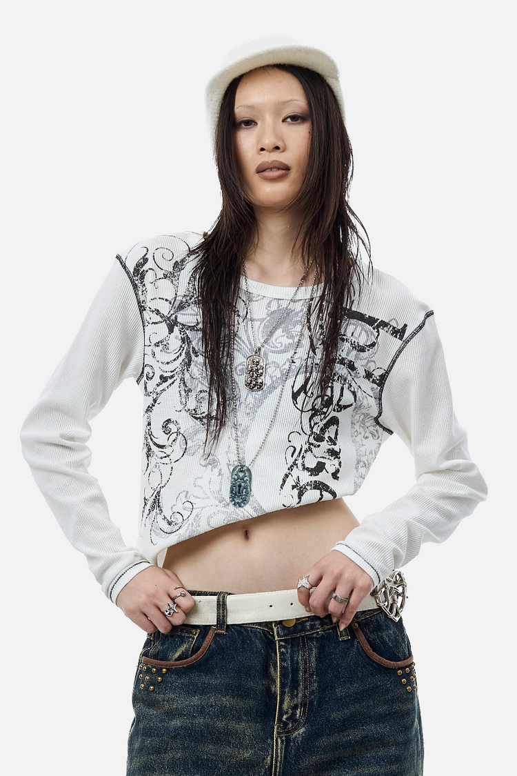 Model wearing the Blessed Thermal Long Sleeve cropped with white belt and baggy jeans