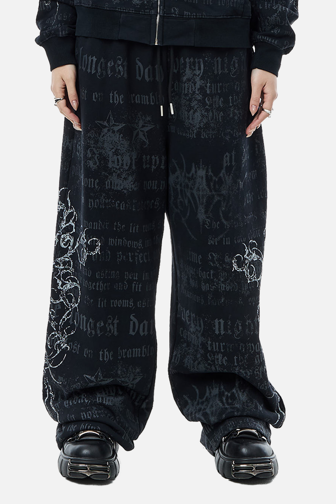 Front view of the wide-leg Sacred Sweatpants with matching zip hoodie and platform shoes