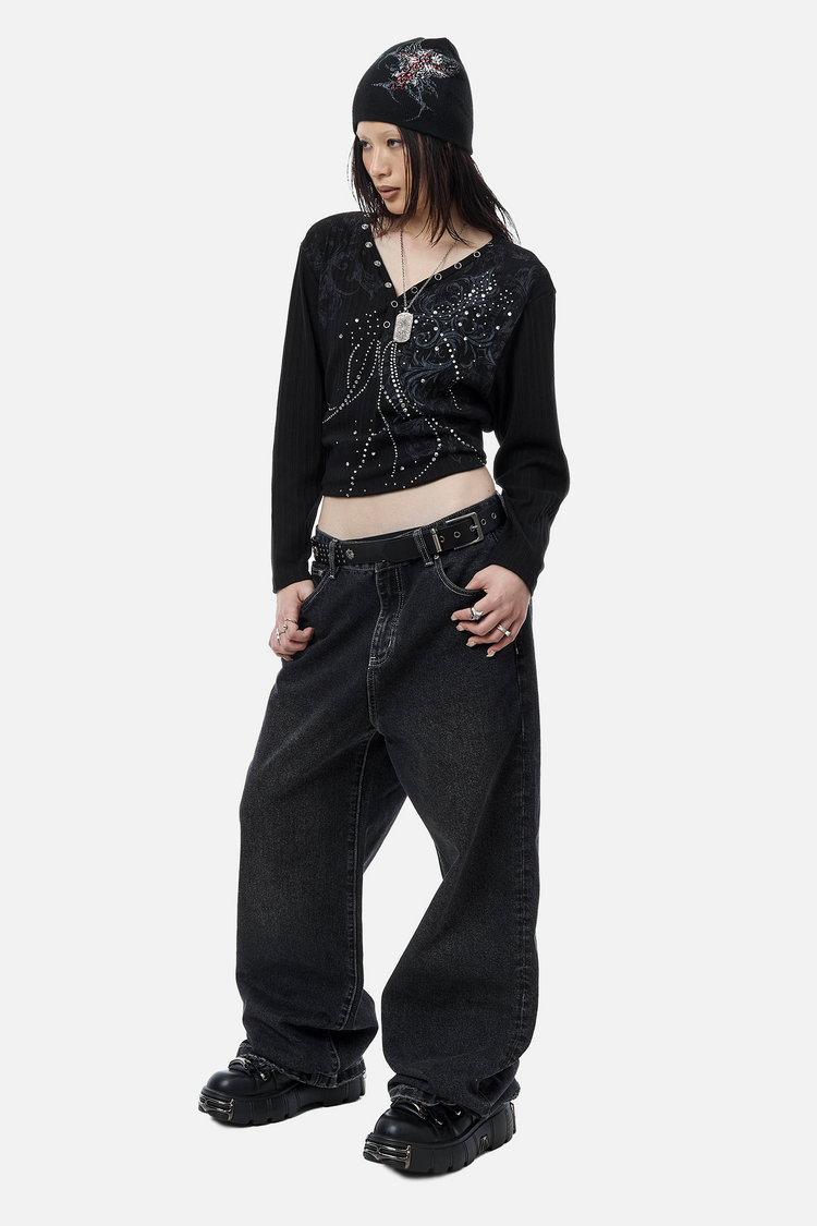 Model in a beanie and cropped studded top wearing the baggy Plaid Patch Outlaw Denim