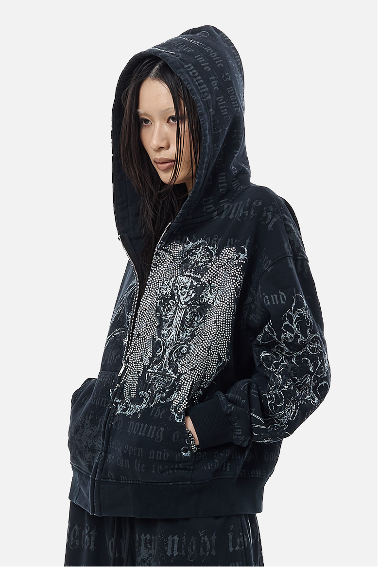 Model with the hood up on the Sacred Zip Hoodie, side view of rhinestone and script print
