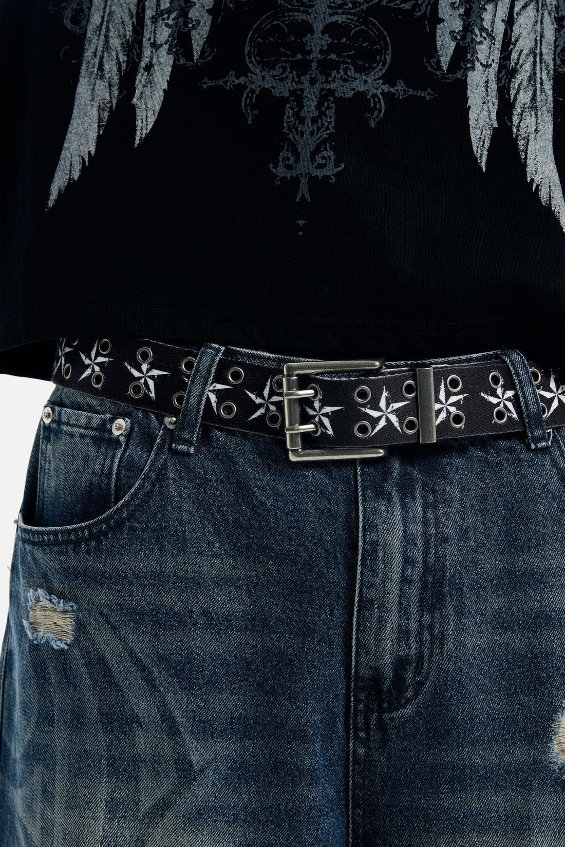 Star Belt worn with distressed blue jeans and a black winged graphic top