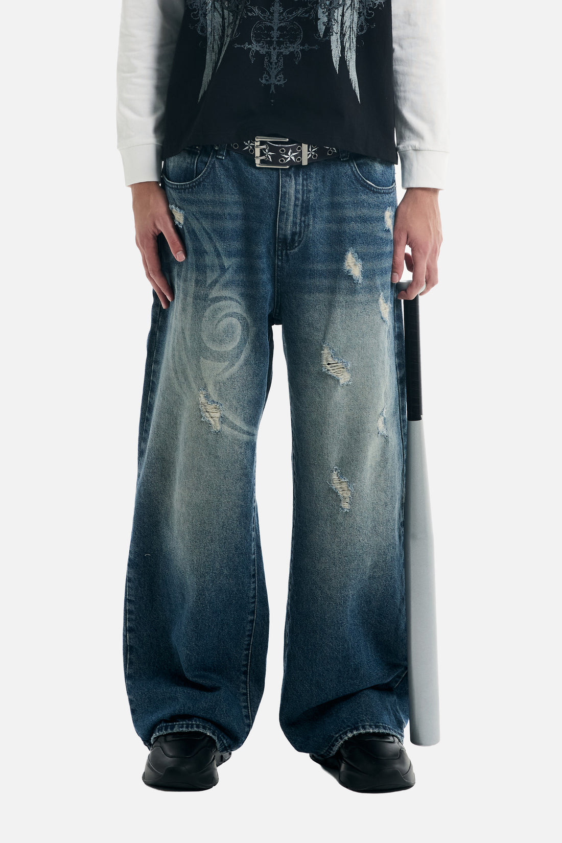 Cropped front view of the Tribal Outlaw Denim worn baggy with black shoes