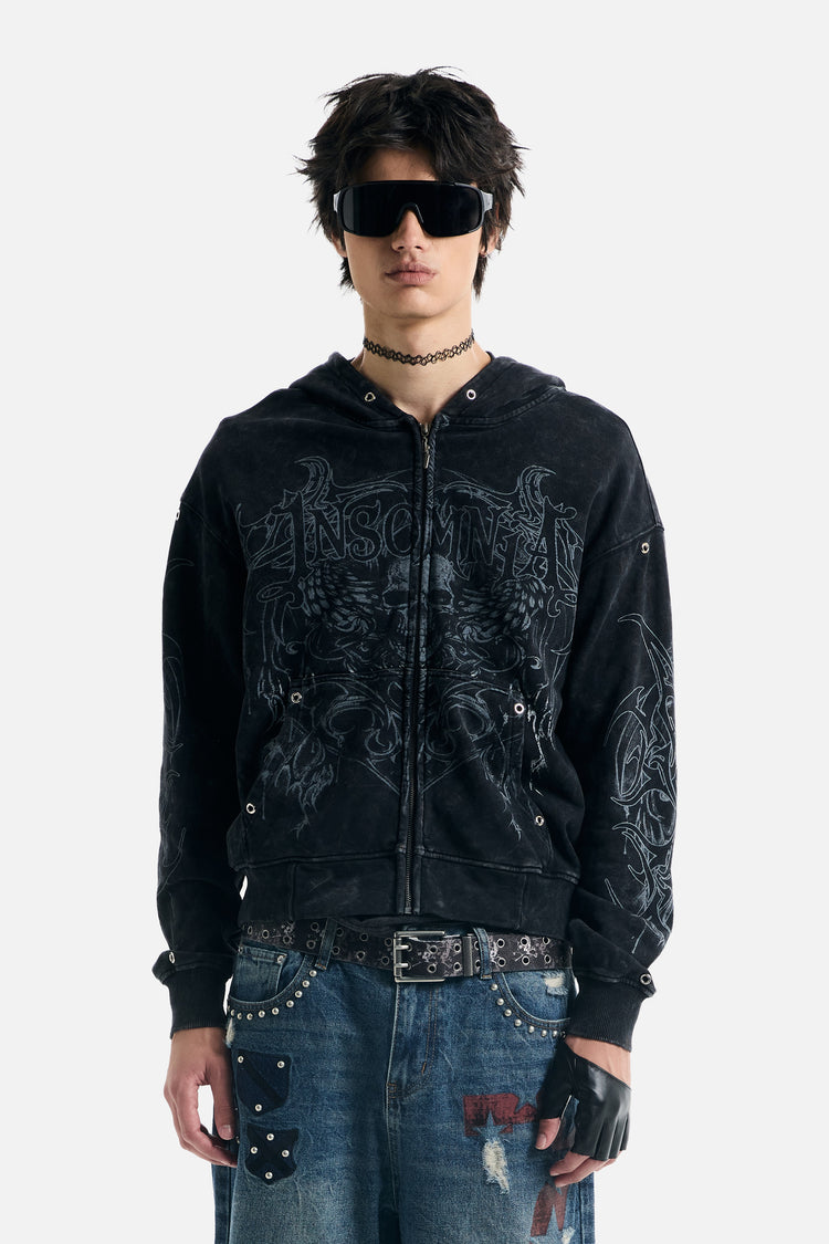 Model wearing the washed black Tribal Zip Up Hoodie with tonal skull and wing print, front view