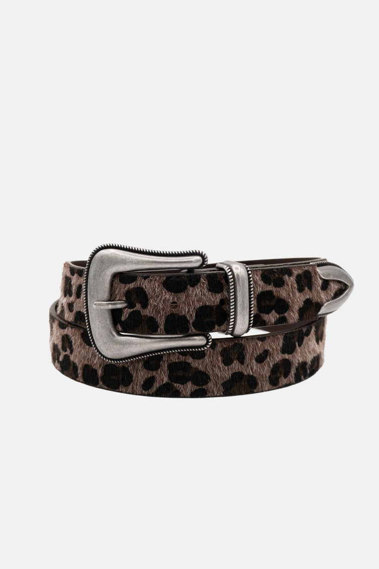 Cheetah Belt rolled on white, showing the engraved silver buckle and tip