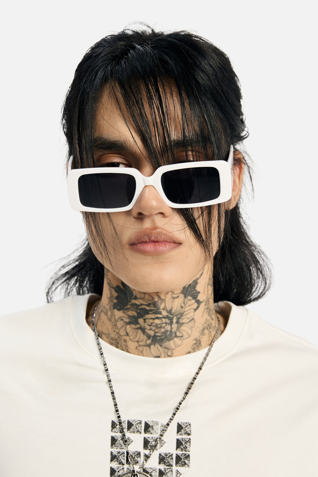 Tattooed model wearing the White Thorns Metal Sunglasses with a white rhinestone cross tee