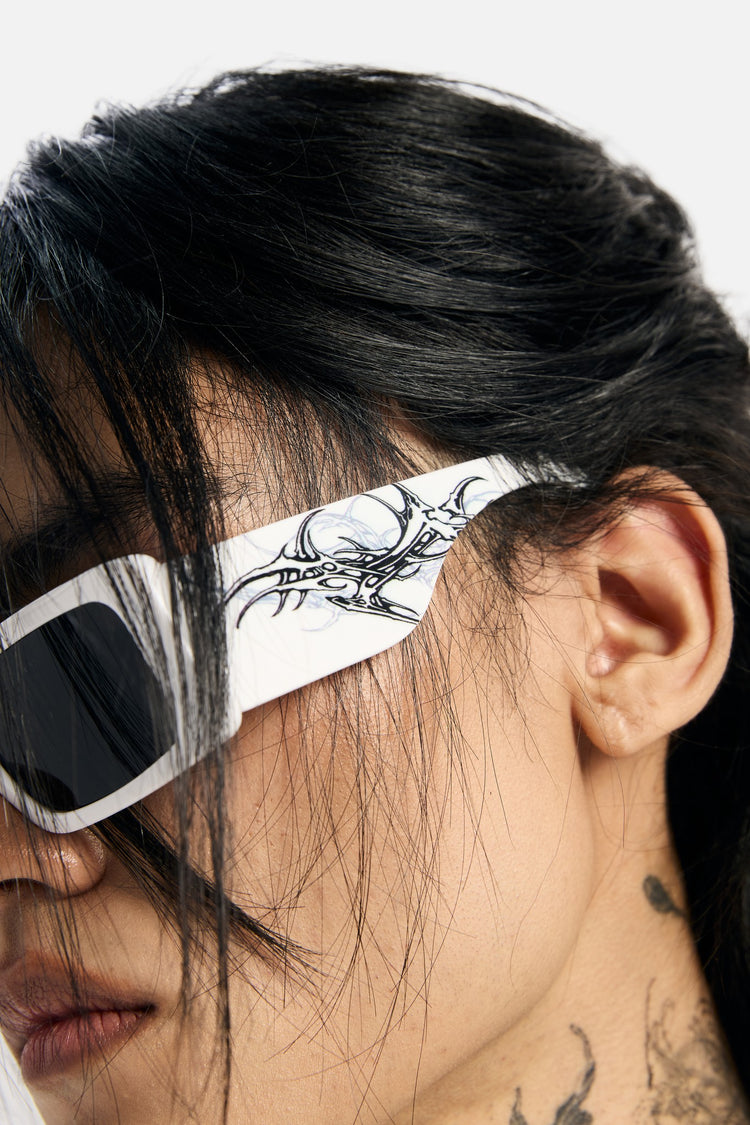 Close-up of the White Thorns Metal Sunglasses' tribal thorn temple detail