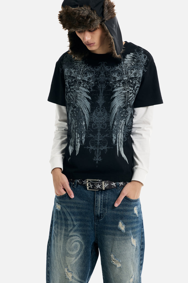 Model leaning forward in the Wings 2Fer with hands in pockets of baggy jeans